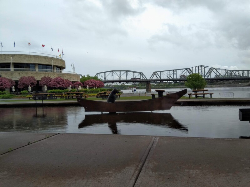 'namaxsala reflects on human relationships with the natural world. The sculpture depicts the artists grandfather helping a wolf cross treacherous waters by boat.